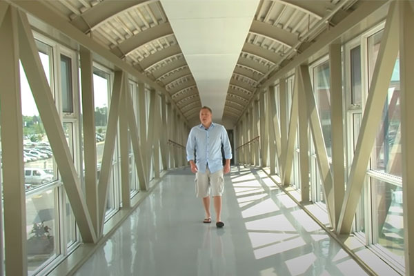 man walking down a hall