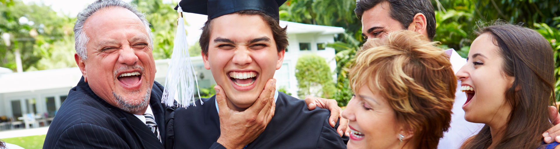 group photo of a family celebrating their son graduating