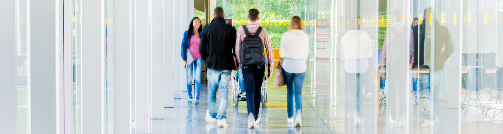 group of students walking down a school hallway toward the exit